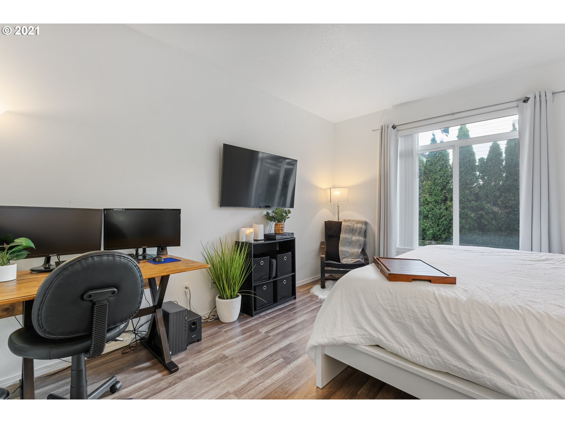 3122 South 2nd Street Ridgefield, WA 98642 - Photo 13 of 30 a bedroom with a bed a large window and wooden floor