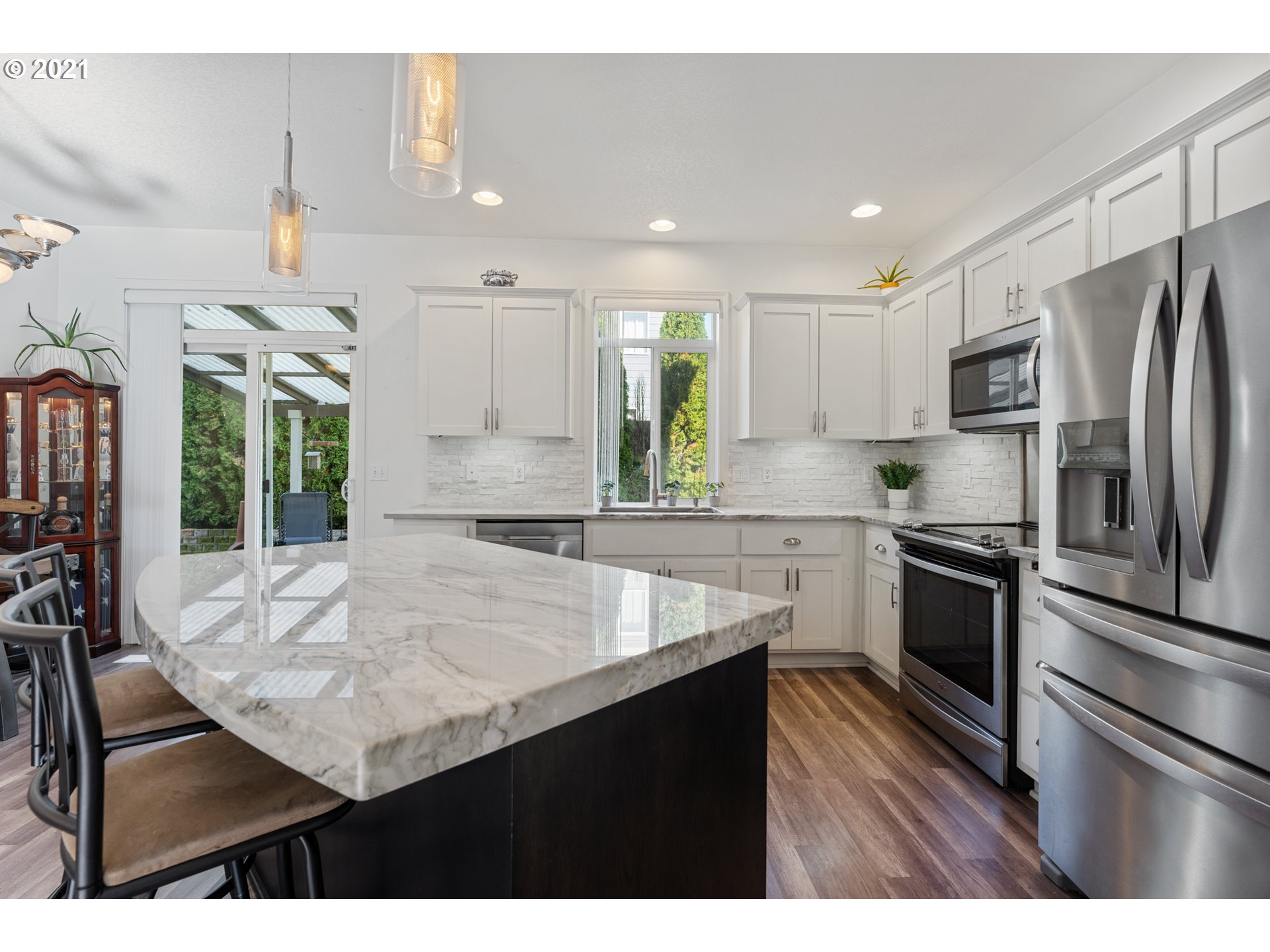 3122 South 2nd Street Ridgefield, WA 98642 - Photo 28 of 30 a kitchen with kitchen island a counter space a sink appliances and cabinets