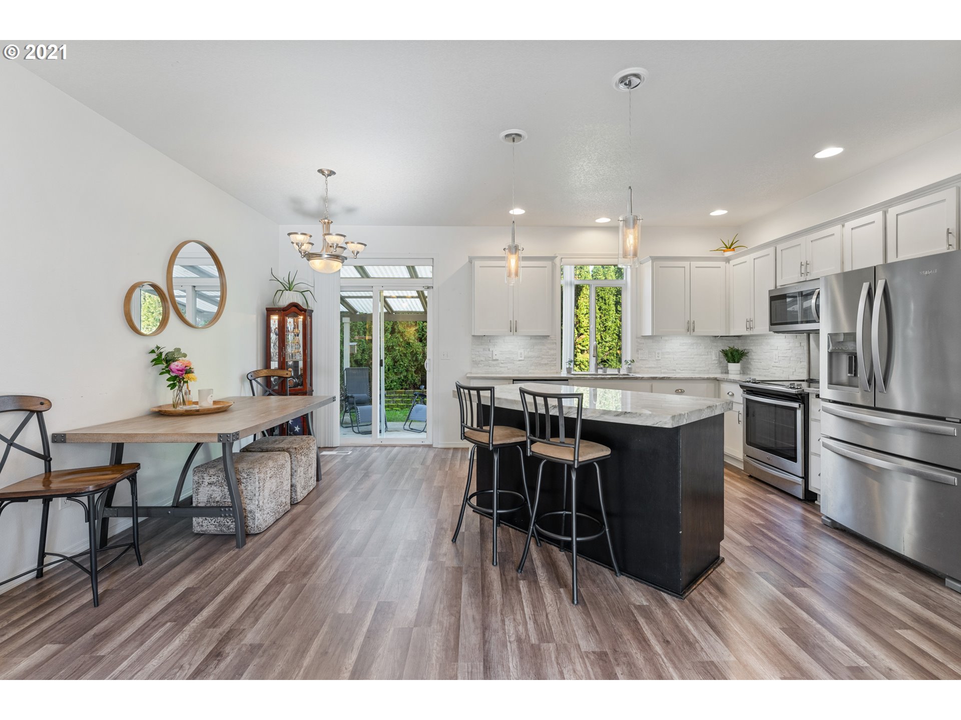 3122 South 2nd Street Ridgefield, WA 98642 - Photo 5 of 30 a kitchen with stainless steel appliances a dining table chairs and wooden floor