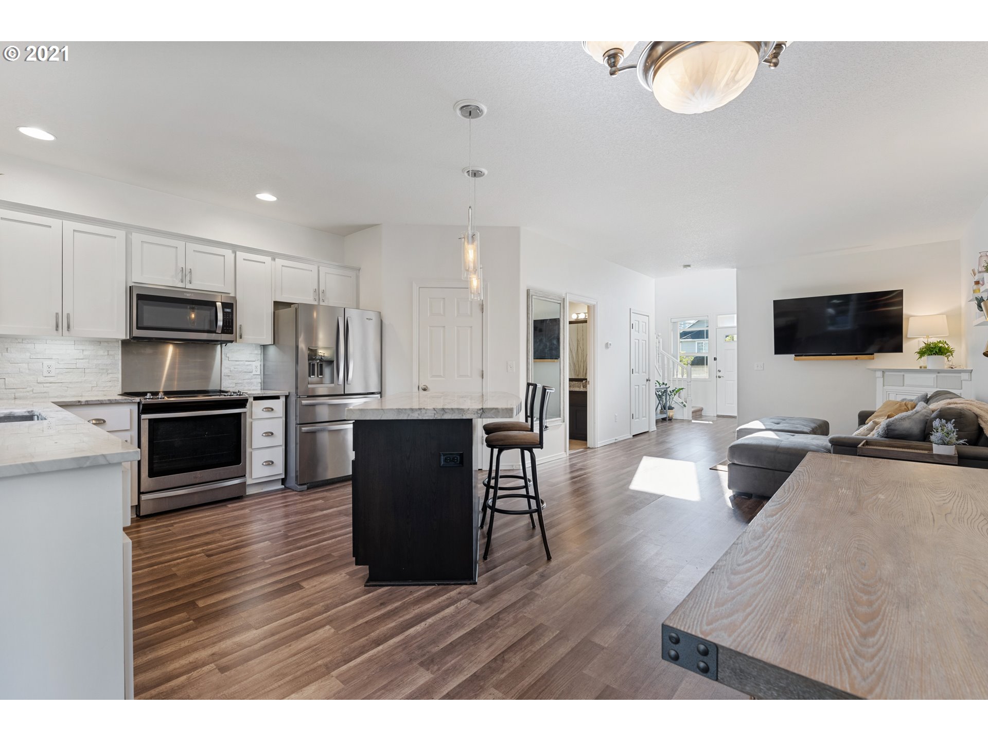 3122 South 2nd Street Ridgefield, WA 98642 - Photo 10 of 30 a living room with furniture wooden floor and kitchen view
