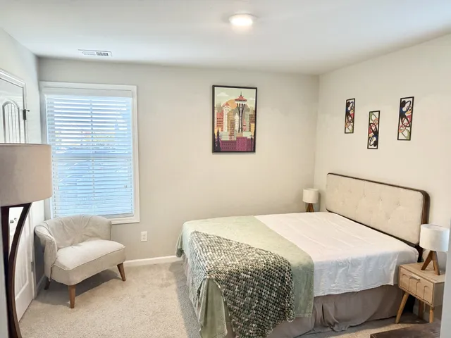 a bedroom with a bed and a couch