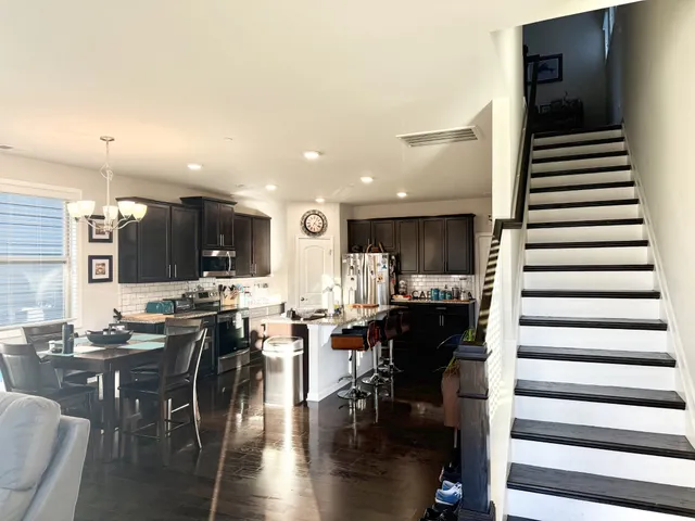 a kitchen with lots of counter and chairs