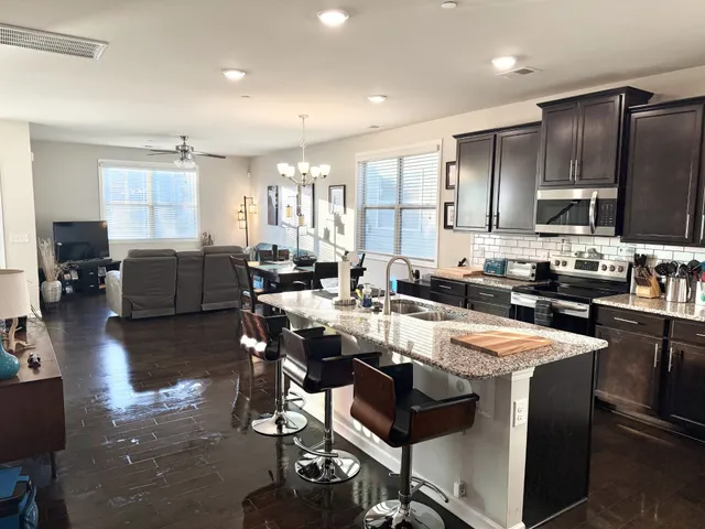 a large kitchen with a table and chairs