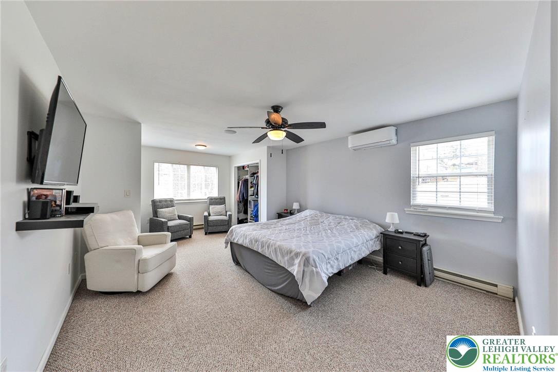 2260 Reo Drive Effort, PA 18330 - Photo 26 of 40 a spacious bedroom with a bed and a chandelier