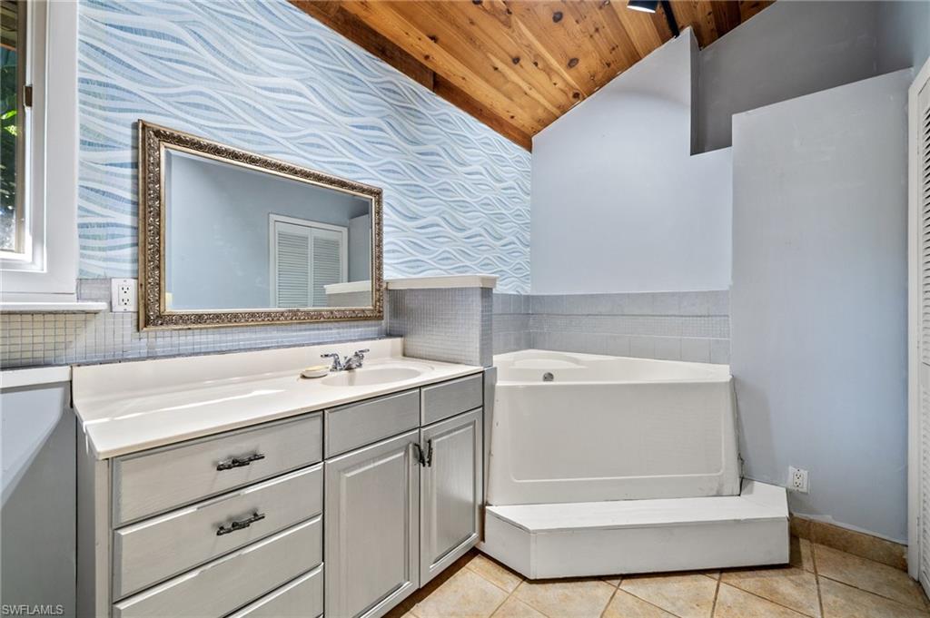 3775 27th Avenue Southwest Naples, FL 34117 - Photo 17 of 38 a bathroom with a sink and a mirror