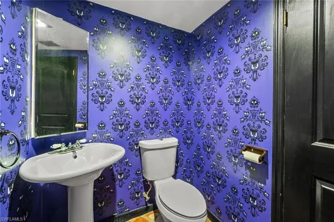 a bathroom with a sink toilet and mirror