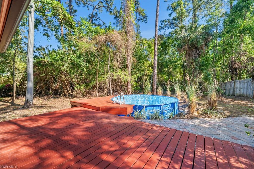 3775 27th Avenue Southwest Naples, FL 34117 - Photo 26 of 38 a view of a tennis ground with large trees
