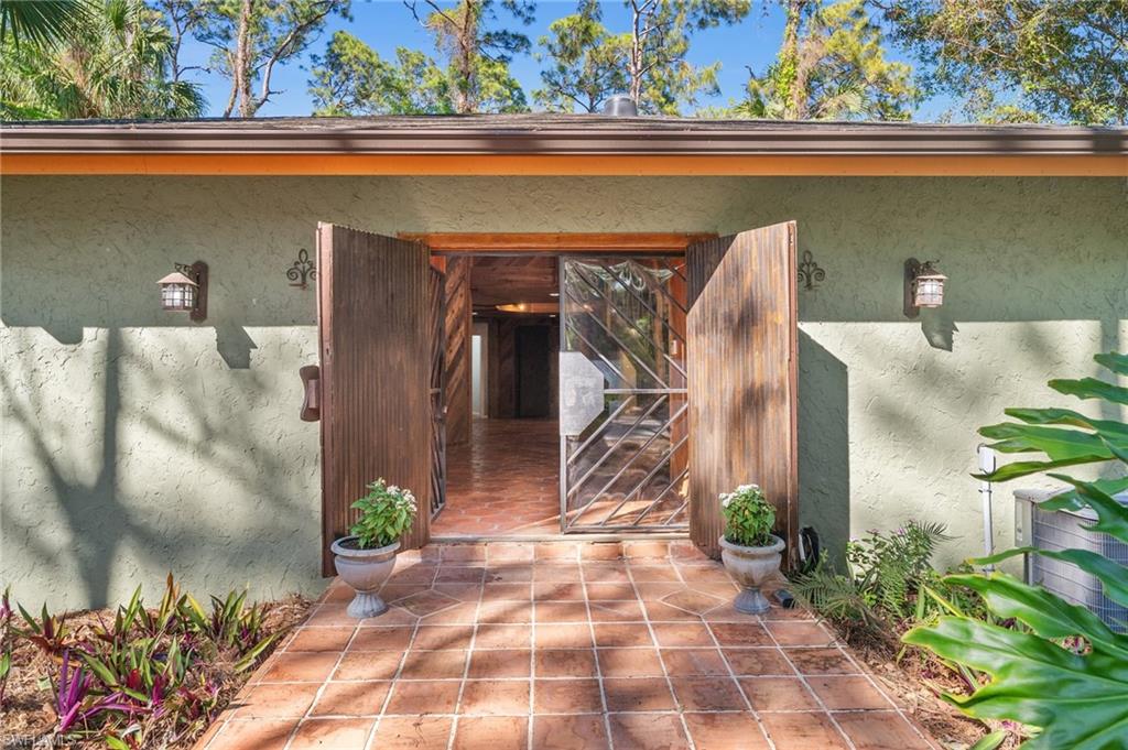 3775 27th Avenue Southwest Naples, FL 34117 - Photo 30 of 38 a view of a potted plants in front of a door