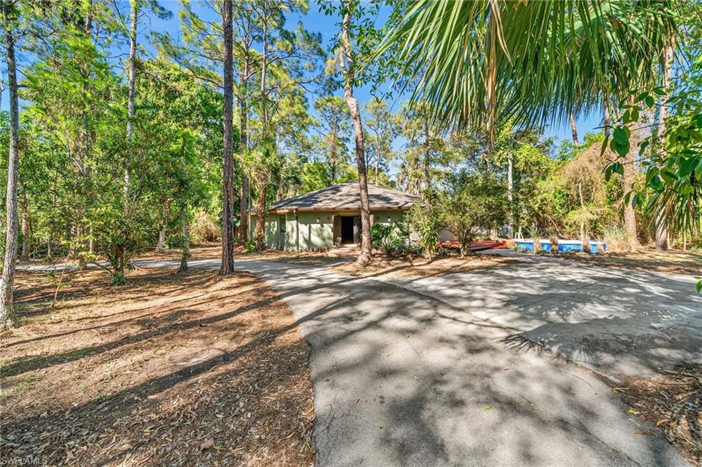 3775 27th Avenue Southwest Naples, FL 34117 - Photo 31 of 38 a front view of a house with a yard