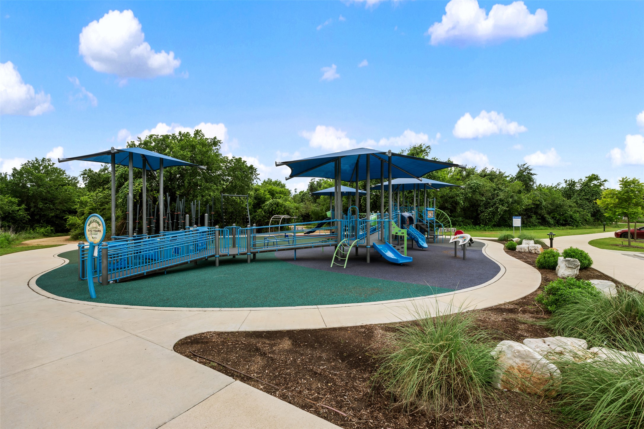 14900 Retha Pass Austin, TX 78725 - Photo 29 of 39 Playground facility featuring blue and green play structures, shade canopies, and ramps
