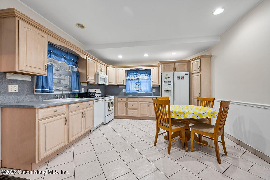 5272 Arthur Kill Road Staten Island, NY 10307 - Photo 11 of 32 a kitchen with cabinets and chairs