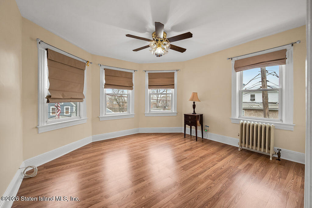 5272 Arthur Kill Road Staten Island, NY 10307 - Photo 17 of 32 a view of empty room with wooden floor and fan