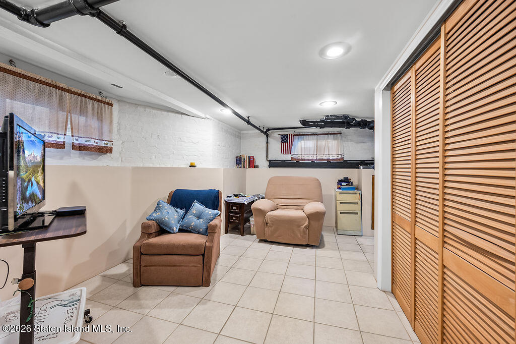 5272 Arthur Kill Road Staten Island, NY 10307 - Photo 23 of 32 a living room with furniture and a flat screen tv