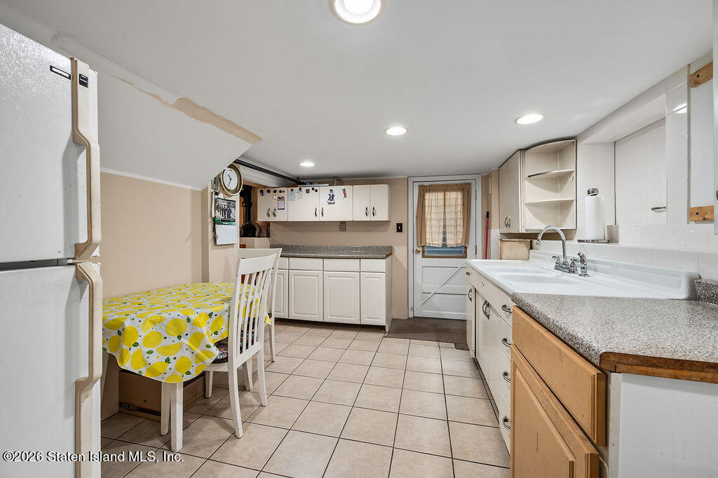 5272 Arthur Kill Road Staten Island, NY 10307 - Photo 25 of 32 a kitchen with a sink appliances and cabinets