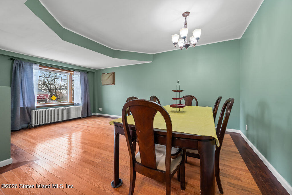5272 Arthur Kill Road Staten Island, NY 10307 - Photo 3 of 32 a view of a dining room with furniture wooden floor and chandelier