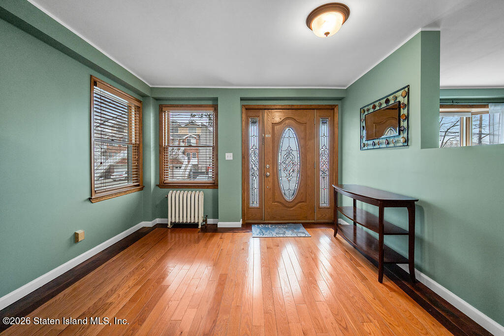 5272 Arthur Kill Road Staten Island, NY 10307 - Photo 4 of 32 a view of empty room with window and wooden floor
