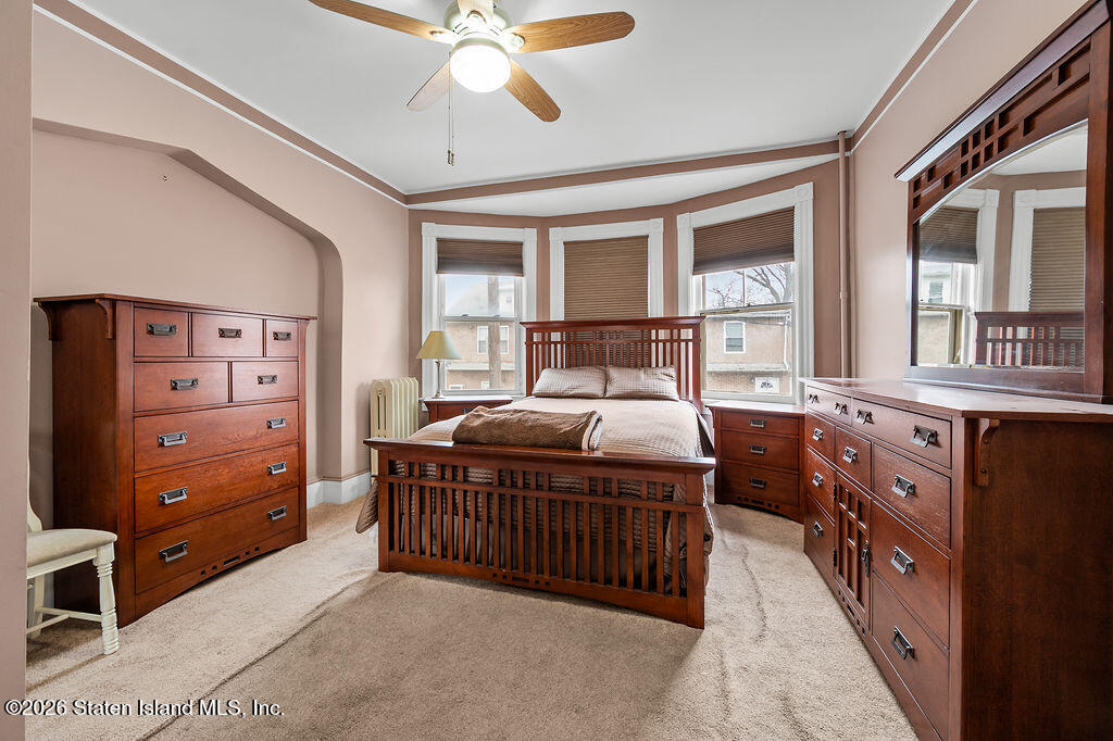 5272 Arthur Kill Road Staten Island, NY 10307 - Photo 8 of 32 a bed room with a bed and a window