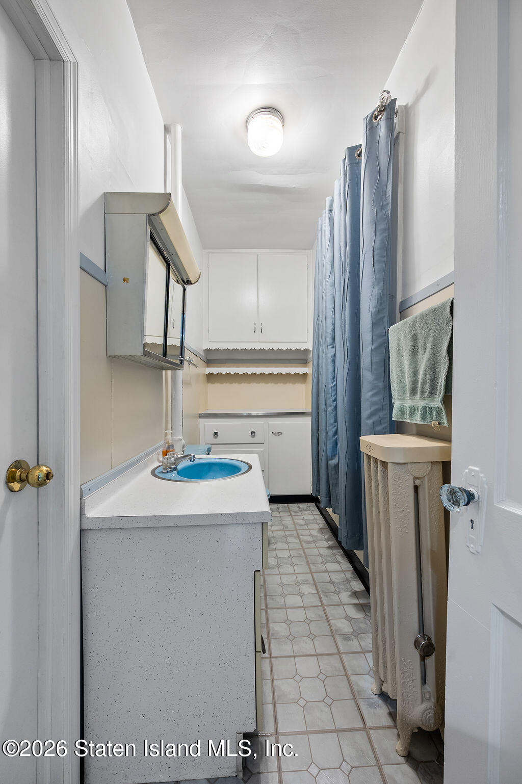 5272 Arthur Kill Road Staten Island, NY 10307 - Photo 10 of 32 a kitchen with a sink a refrigerator and cabinets