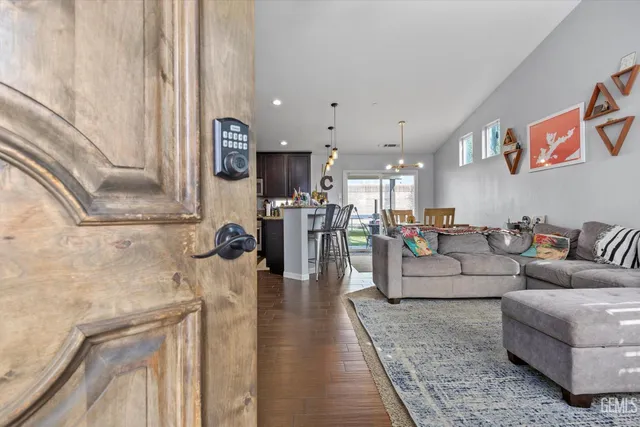 a living room with furniture and kitchen view