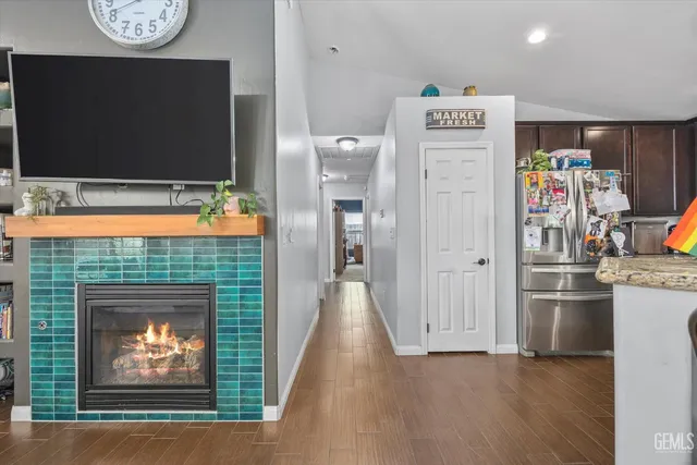 a living room with fireplace furniture and a flat screen tv