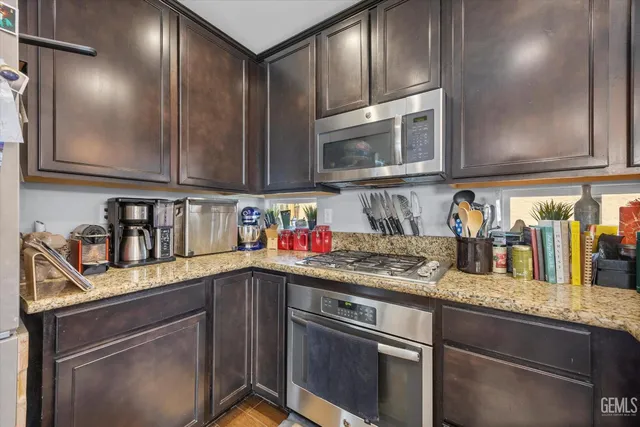 a kitchen with a sink cabinets and stainless steel appliances