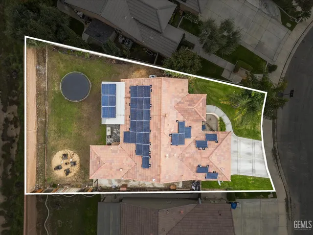 a front view of a house with a yard and potted plants