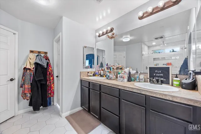 a kitchen with a sink and white cabinets