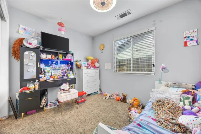 a bedroom with baby bed toys and baby crib