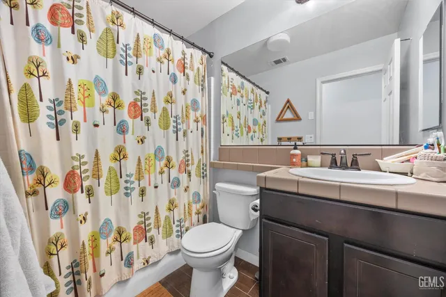 a bedroom with filled bed and a window