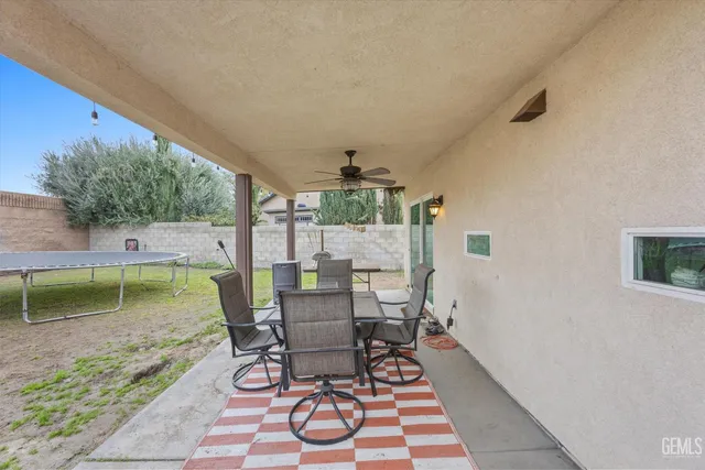 a swimming pool with outdoor seating and yard