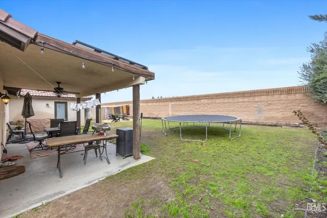 a view of a house with backyard porch and sitting area
