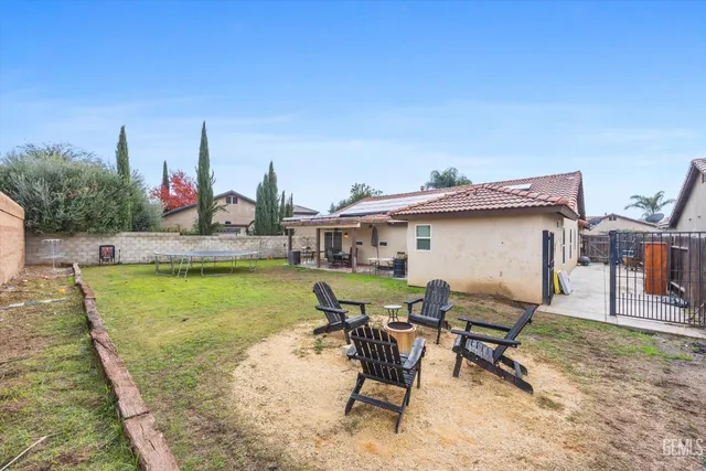 a view of a patio with table and chairs with wooden floor and fence