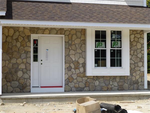 53 Baldwin Road, Unit 1703 Billerica, MA 01821 - Photo 4 of 15 a front view of a house with a yard