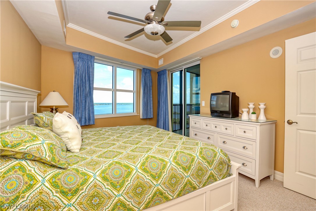 2797 First Street, Unit 1802 Fort Myers, FL 33916 - Photo 17 of 32 a bedroom with a large bed and a flat tv screen on dresser