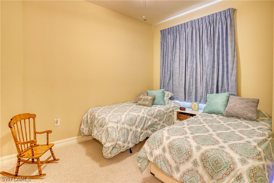 2797 First Street, Unit 1802 Fort Myers, FL 33916 - Photo 20 of 32 a bedroom with two beds and painting on the wall