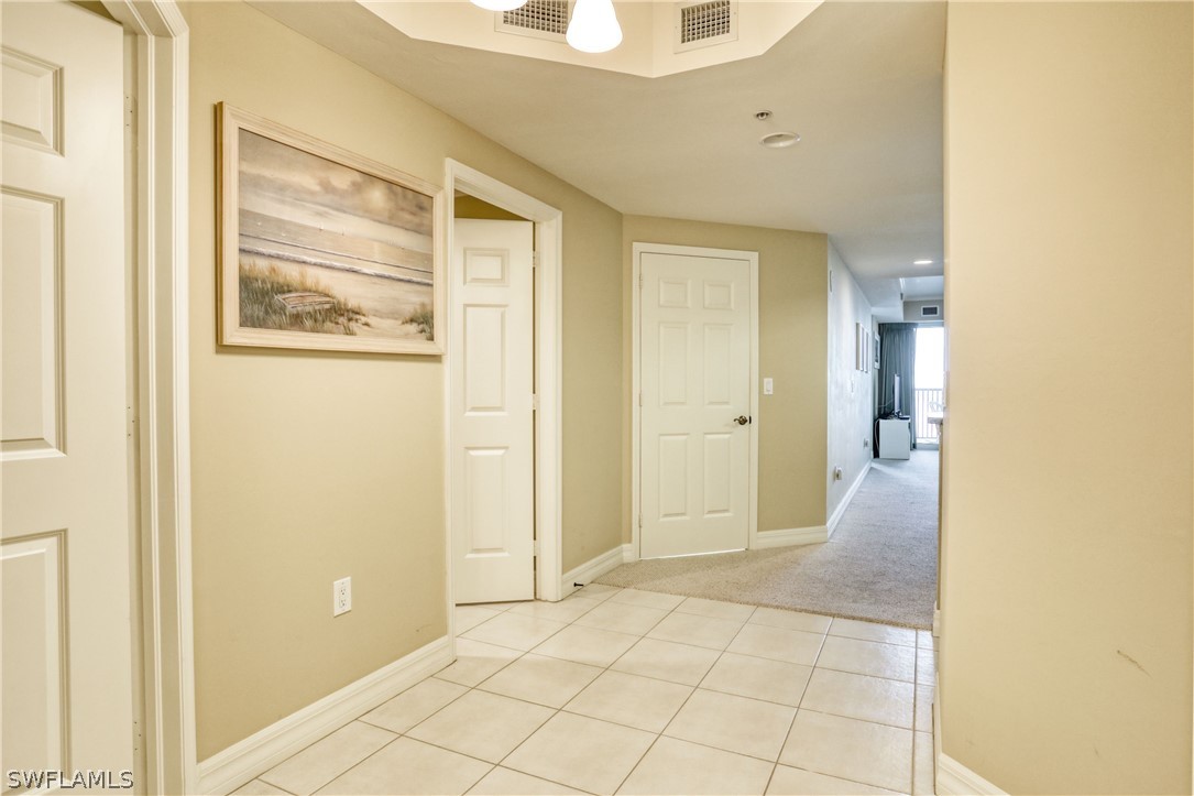 2797 First Street, Unit 1802 Fort Myers, FL 33916 - Photo 23 of 32 a view of a hallway with wooden floor and a bathroom