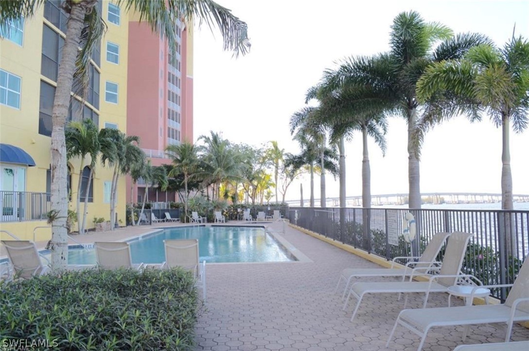 2797 First Street, Unit 1802 Fort Myers, FL 33916 - Photo 26 of 32 a swimming pool with palm tree