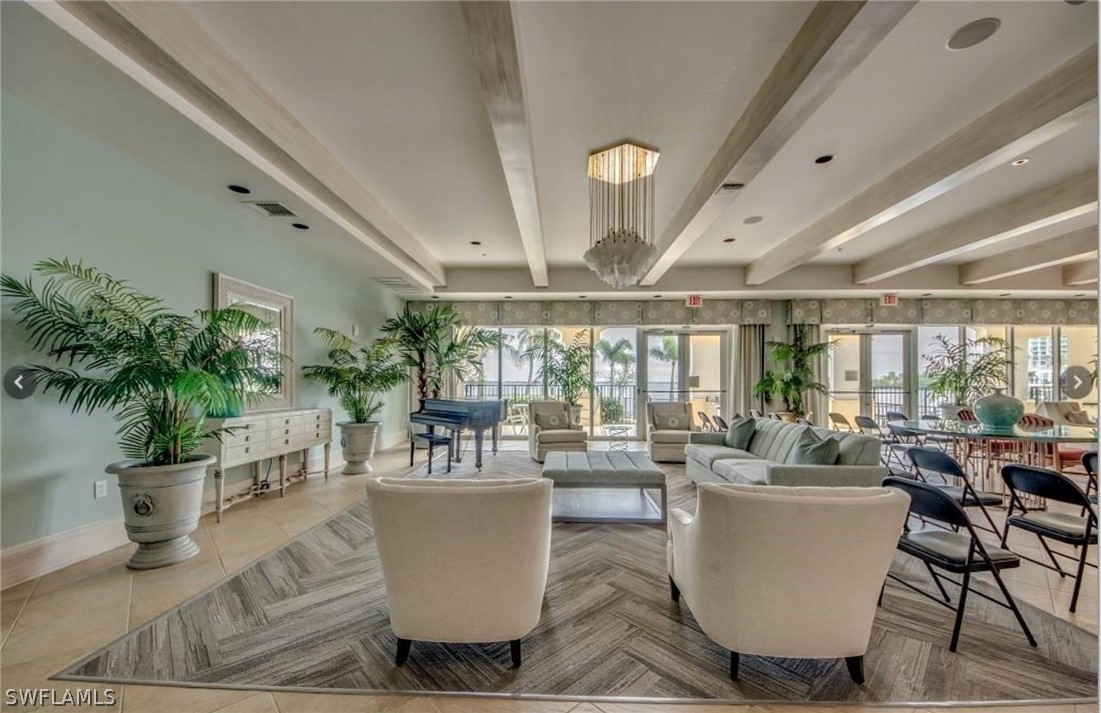 2797 First Street, Unit 1802 Fort Myers, FL 33916 - Photo 27 of 32 a living room with a large window a table and chairs