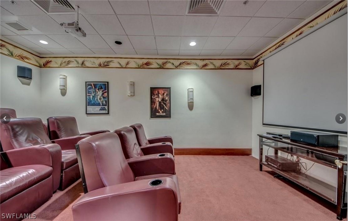2797 First Street, Unit 1802 Fort Myers, FL 33916 - Photo 28 of 32 a media room with lots of chairs and a projector screen