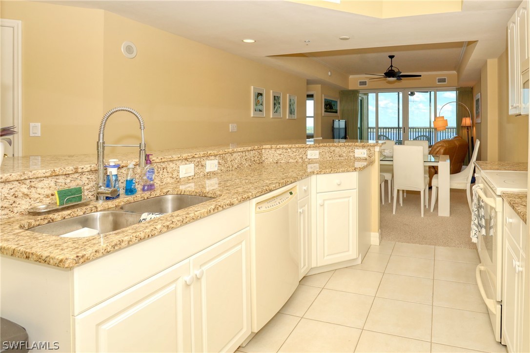 2797 First Street, Unit 1802 Fort Myers, FL 33916 - Photo 6 of 32 a large kitchen with granite countertop a sink and a stove top oven