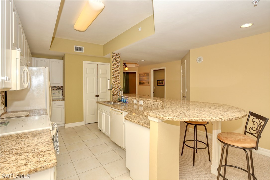 2797 First Street, Unit 1802 Fort Myers, FL 33916 - Photo 7 of 32 a bathroom with a granite countertop sink and a mirror