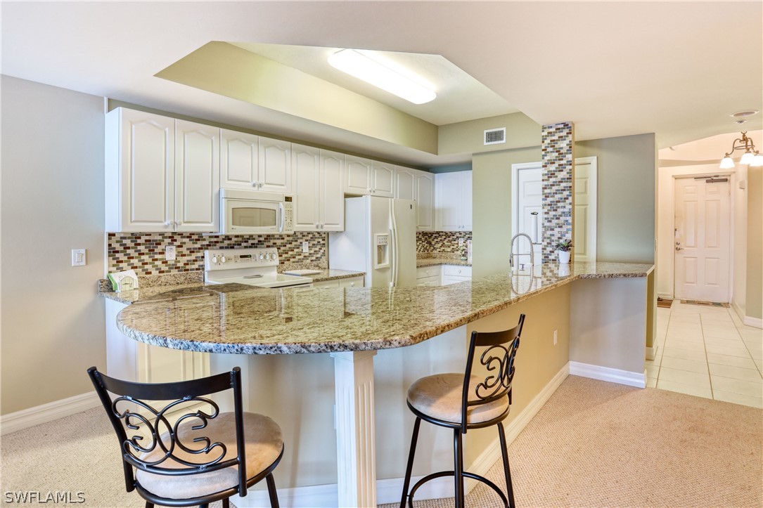 2797 First Street, Unit 1802 Fort Myers, FL 33916 - Photo 8 of 32 a kitchen with stainless steel appliances granite countertop a sink and cabinets