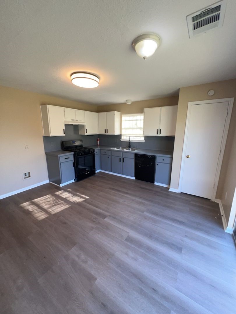 16410 Amy Ridge Road Houston, TX 77053 - Photo 3 of 17 a large kitchen with a stove wooden cabinets and wooden floor