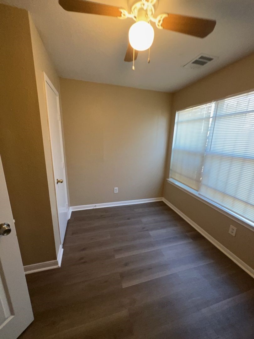 16410 Amy Ridge Road Houston, TX 77053 - Photo 9 of 17 a view of an empty room with wooden floor and a window