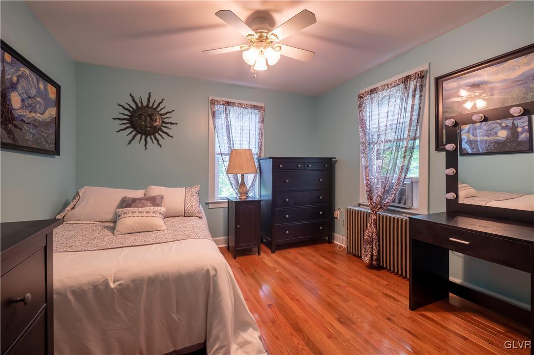 696 Cherry Hill Road Nazareth, PA 18064 - Photo 36 of 46 a bedroom with a bed and a chandelier
