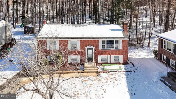 an aerial view of a house with yard and sitting area
