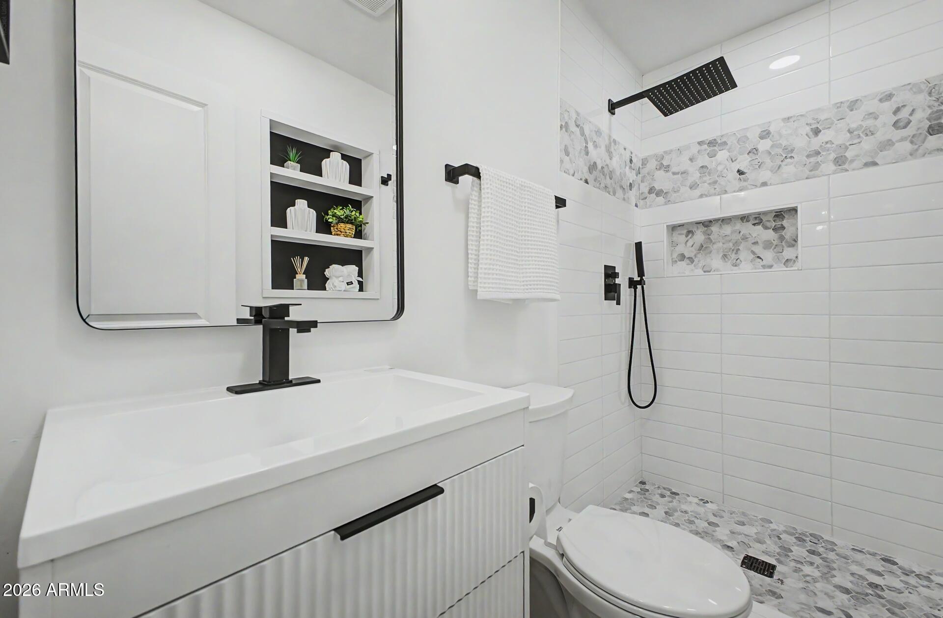 5232 West Hearn Road Glendale, AZ 85306 - Photo 12 of 32 a bathroom with a sink toilet and shower