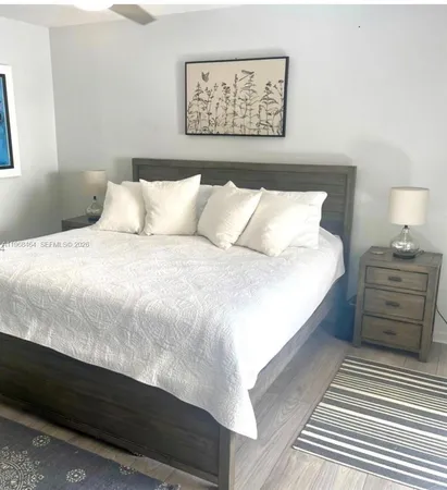 a bedroom with a bed and a night stand