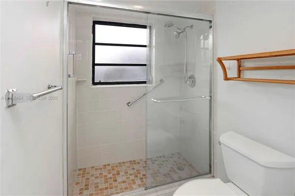 a bathroom with a shower and a toilet