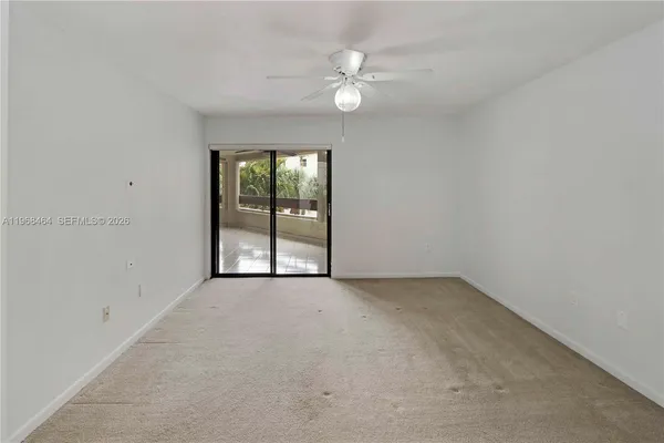an empty room with chandelier fan